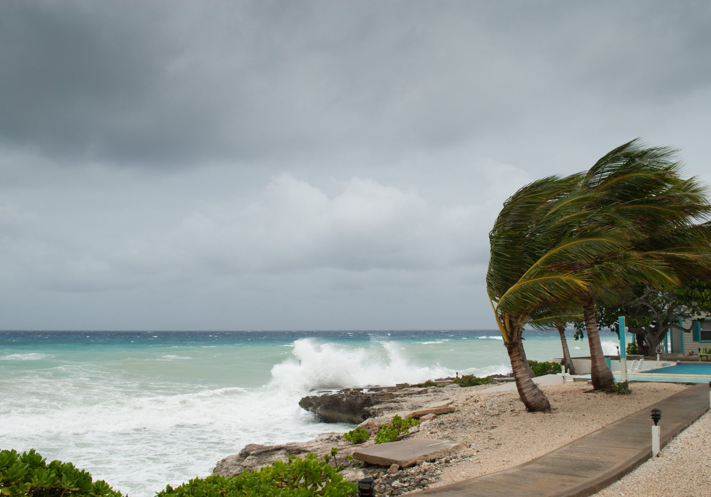A hurricane is about to batter this caribbean beach hut. The seas are raging and the skies show the tropical storm as the power of nature is demonstrated. Waves crash on the shore A hurricane is about to batter this caribbean beach hut. The seas are raging and the skies show the tropical storm as the power of nature is demonstrated. Waves crash on the shore